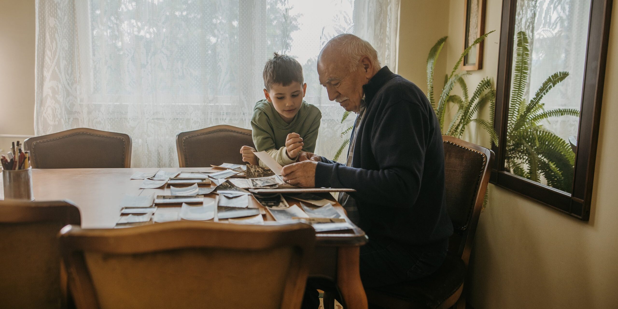 Grandfather showing pictures to grandson